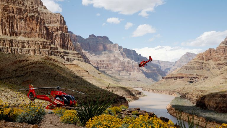 Two Las Vegas private helicopter tours landing at the bottom of the Grand Canyon