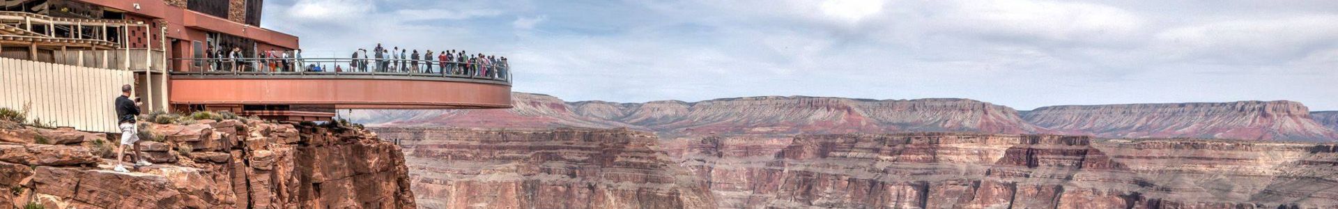 guests stand in the middle of the Grand Canyon atop the Skywalk Bridge