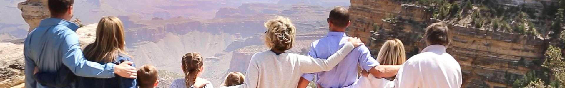 a large family hugs at a Grand Canyon National Park lookout point