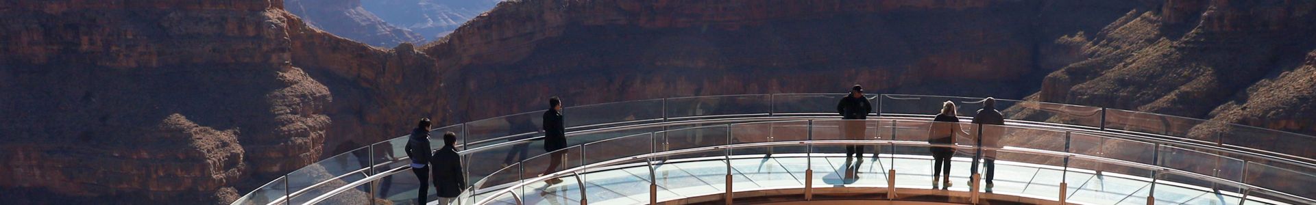Visitors to the Grand Canyon West stand atop the Skywalk in front of Eagle Point
