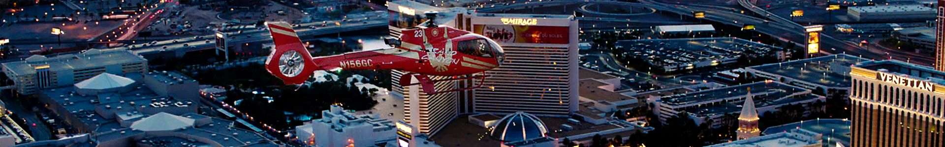 A Las Vegas helicopter tour flies over the Strip casinos at night