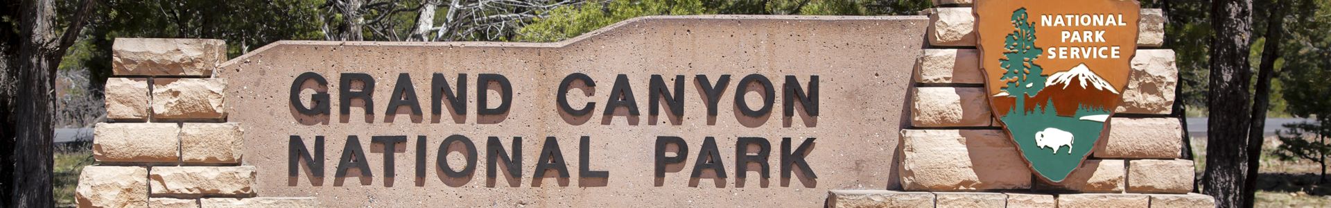 A stone sign designating the entrance to the Grand Canyon National Park