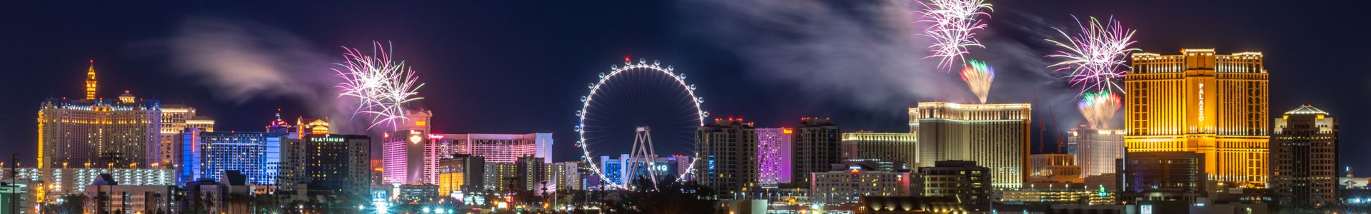 red helicopter flying over the Las Vegas Strip during 4th of July fireworks