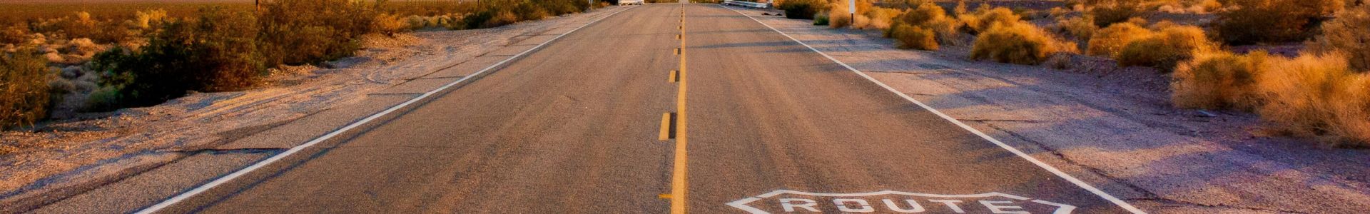 A section of the historic Route 66, an open road under a clear blue sky