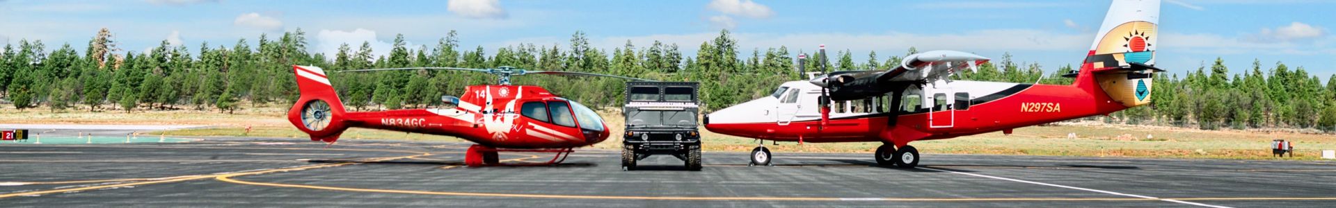 helicopter hummer and twin otter plane next to each other
