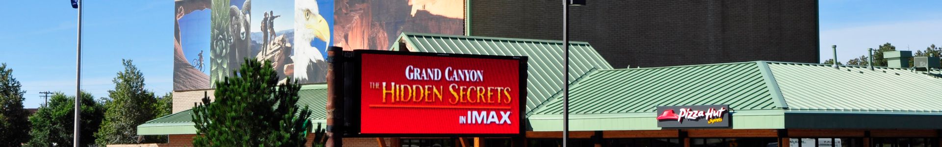 A billboard outside an IMAX theater advertises a Grand Canyon film.