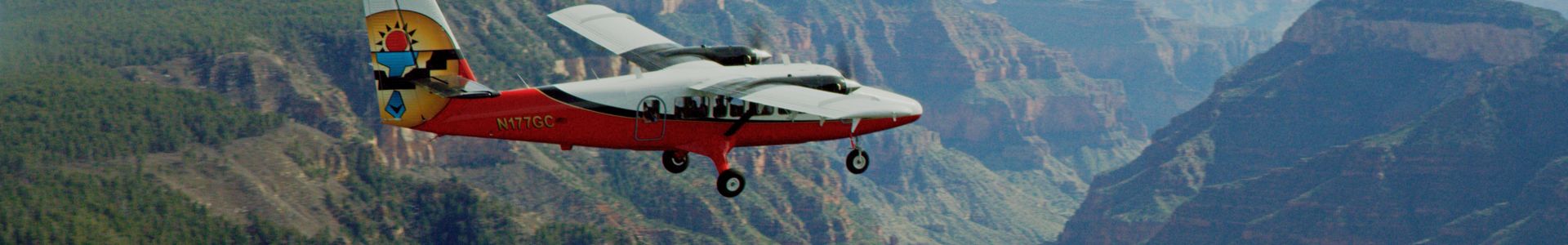 A sightseeing airplane flies over the Grand Canyon