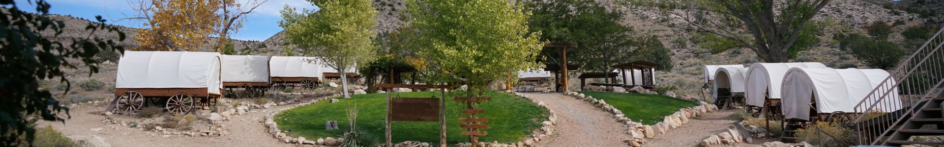 Bar 10 Ranch exterior with covered wagons scattered across the landscape