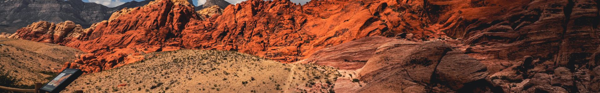 Colorful Red Rock Canyon viewpoint beneath partially cloudy skies