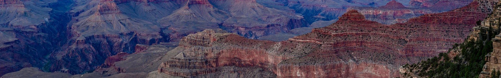a Grand Canyon National Park viewpoint seen at sunset amidst a purple sky