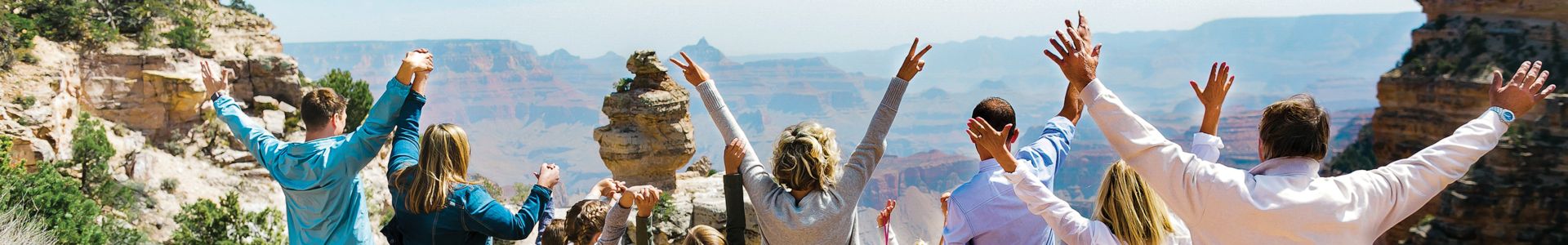 passengers aboard a military-style Hummer vehicle parked at a Grand Canyon lookout point