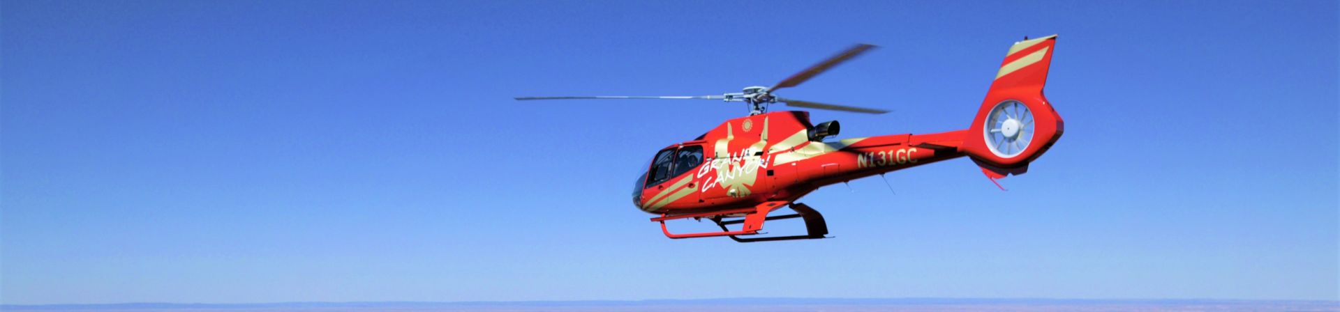 An EcoStar Helicopter flies over the Grand Canyon South Rim