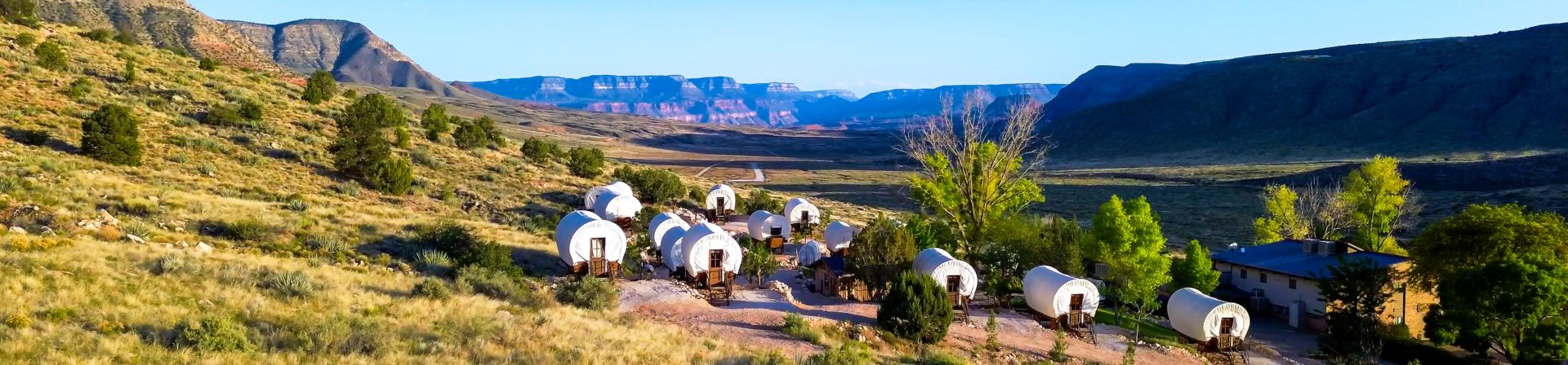 Bar 10 Ranch and its covered wagons located on property with desert scenery surrounding it