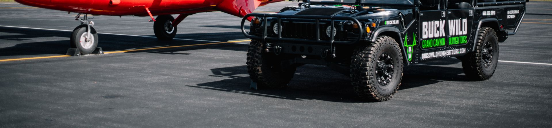 A Twin Otter airplane and a Buck Wild Hummer vehicle seen together on Papillon's tarmac