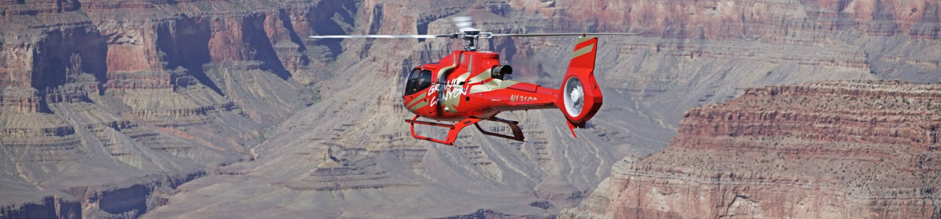 A Grand Canyon helicopter tour flies over the South Rim landscape