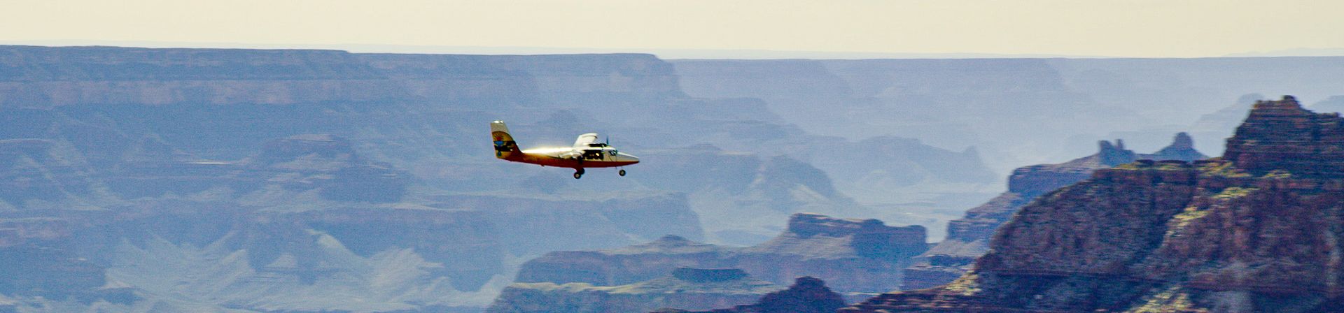 A sightseeing airplane tour seen with the Grand Canyon walls in the distance