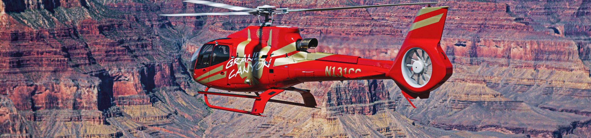 An Ecostar helicopter flies over the Grand Canyon South Rim