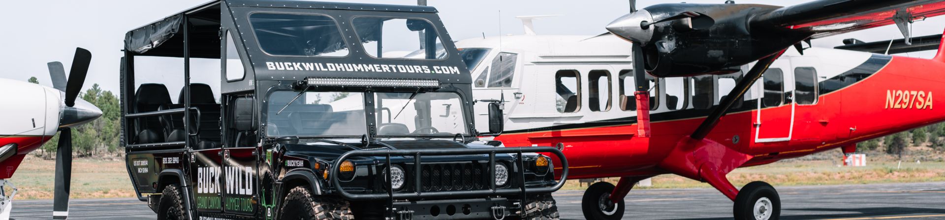 A helicopter and a Hummer vehicle from Papillon's fleet parked art the South Rim