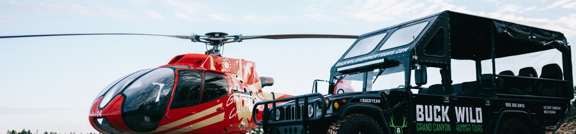 An Ecostar helicopter and a Buck Wild Hummer parked at the South Rim