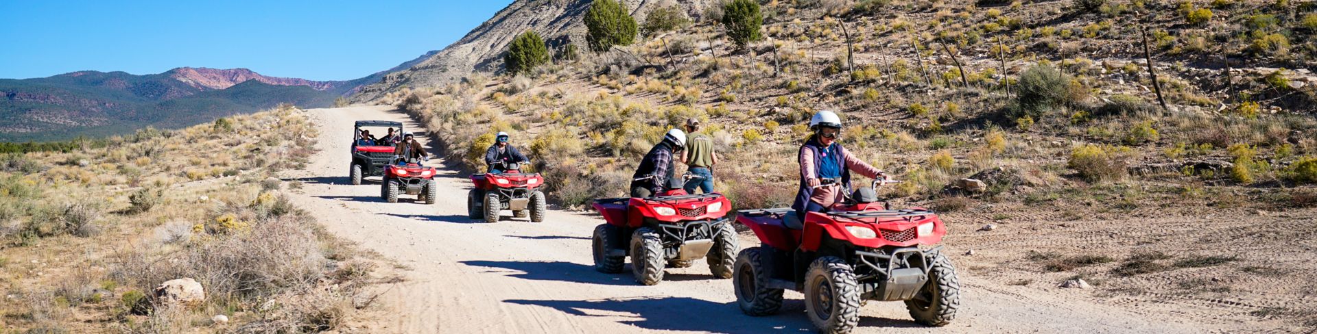 Visitors to Bar 10 Ranch ride ATVs through the desert scenery en route to a scenic overlook