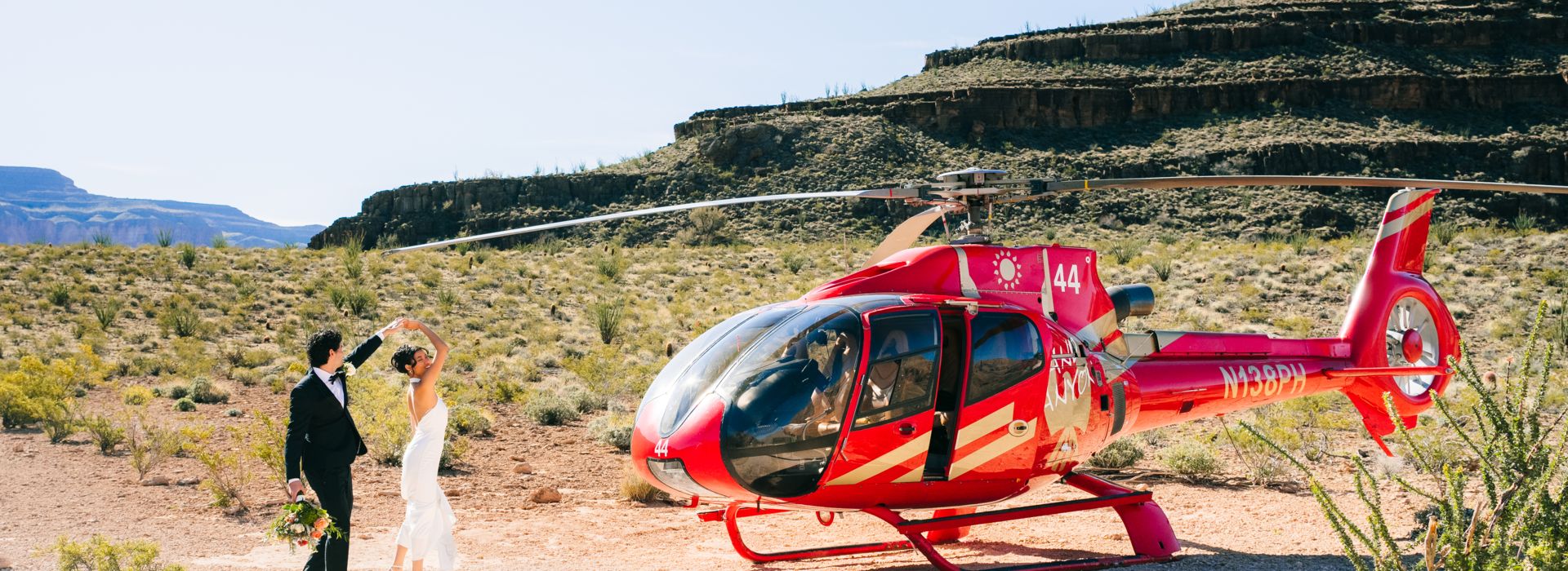 a couple dances at the bottom of the west rim after landing in a helicopter tour for a grand canyon wedding