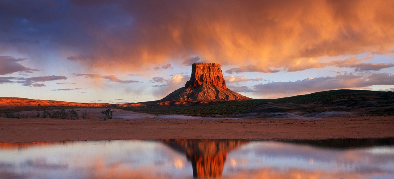 Tower Butte in Page, Arizona seen reflected on water at sunset