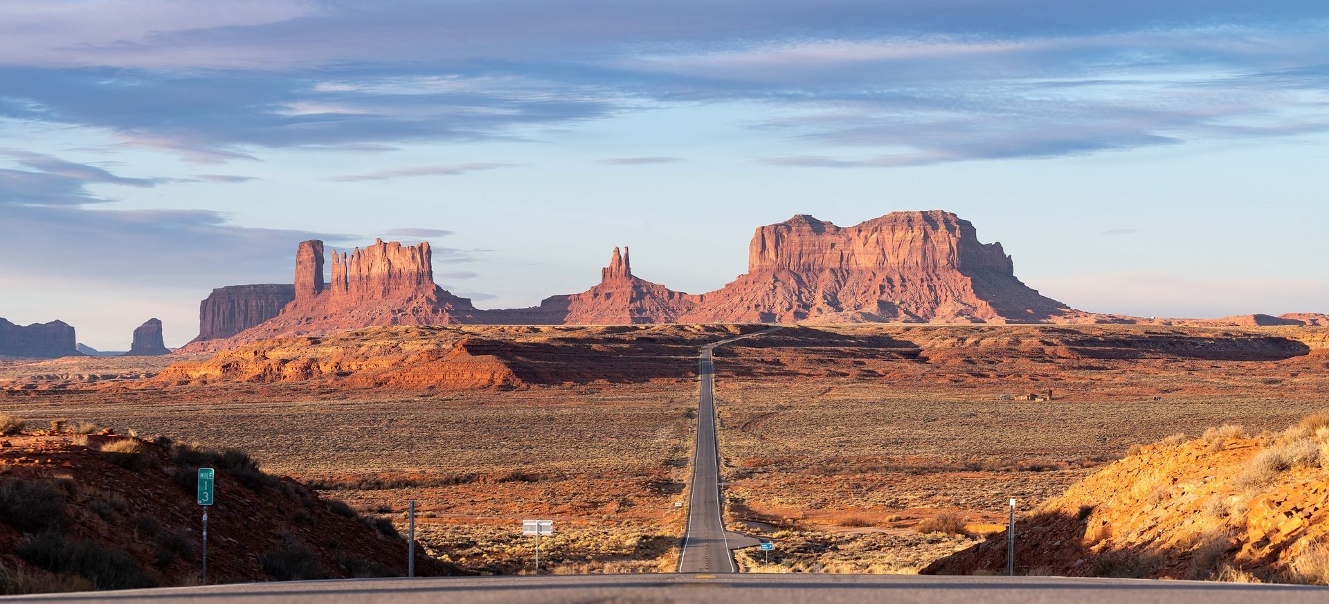 a Monument Valley landscape split in half by a highway road