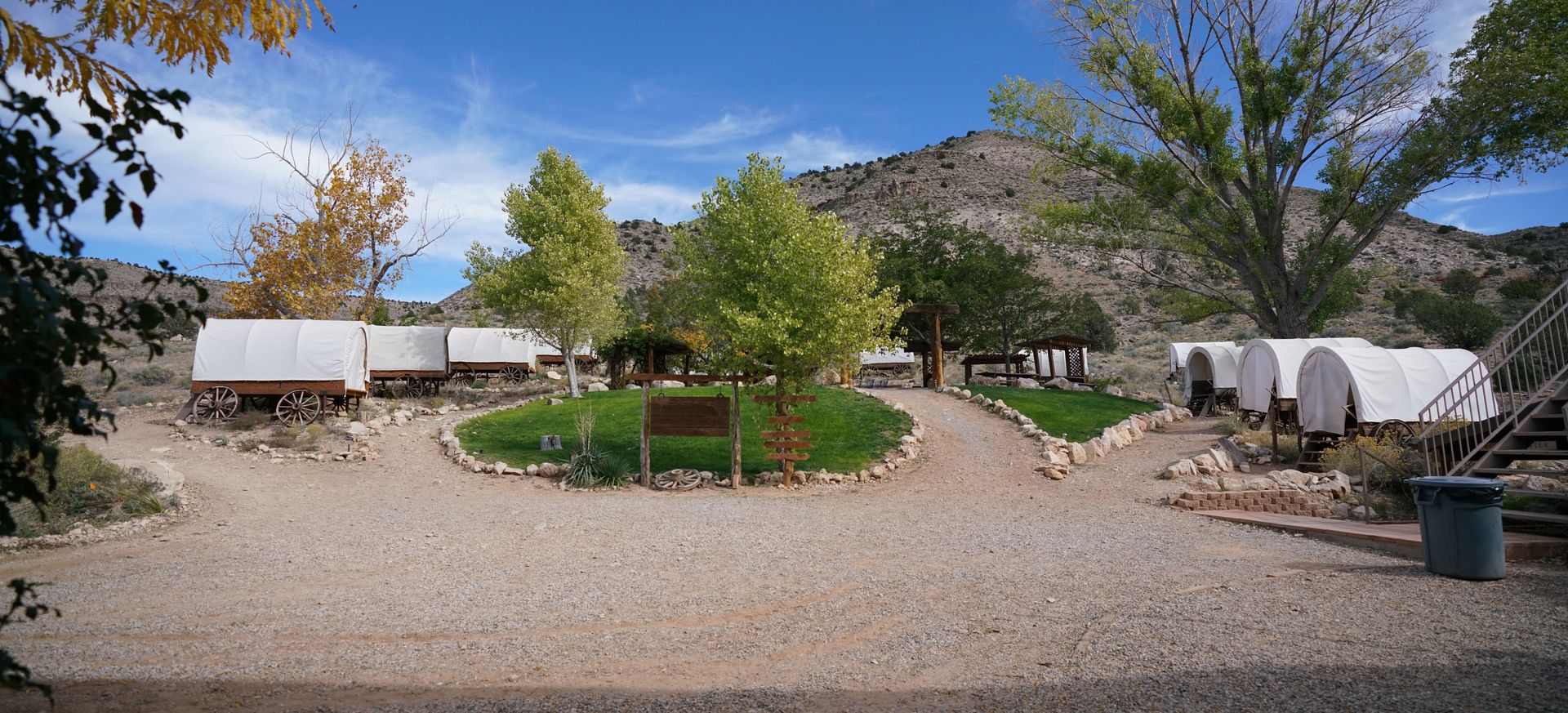 Bar 10 Ranch exterior with covered wagons scattered across the landscape