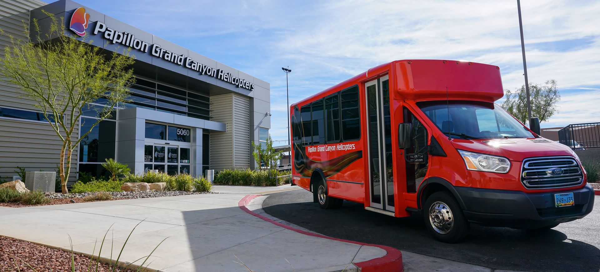 RS18890_DSC03355-new-red-painted-transportation-bus-parked-in-front-of-papillon-helicopters-las-vegas-terminal