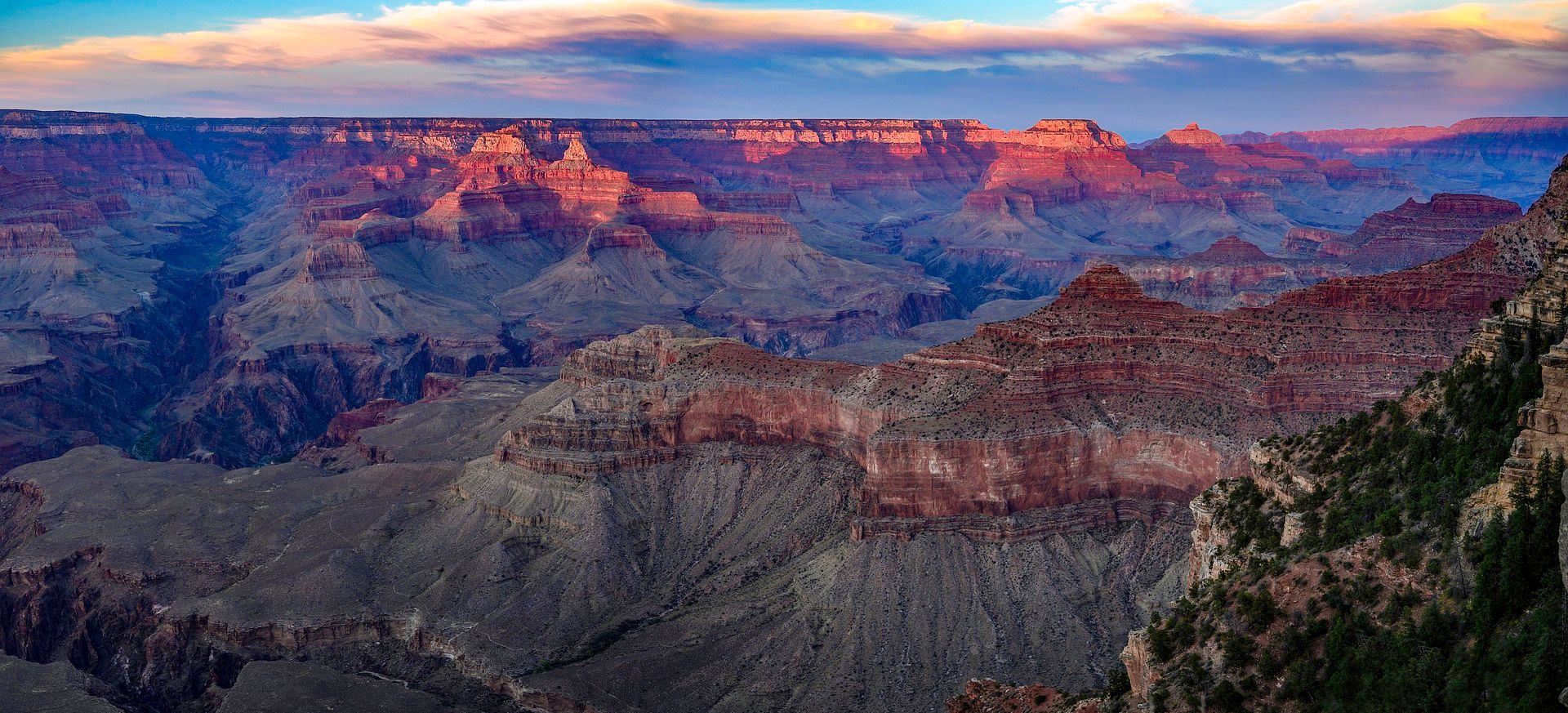a Grand Canyon National Park viewpoint seen at sunset amidst a purple sky