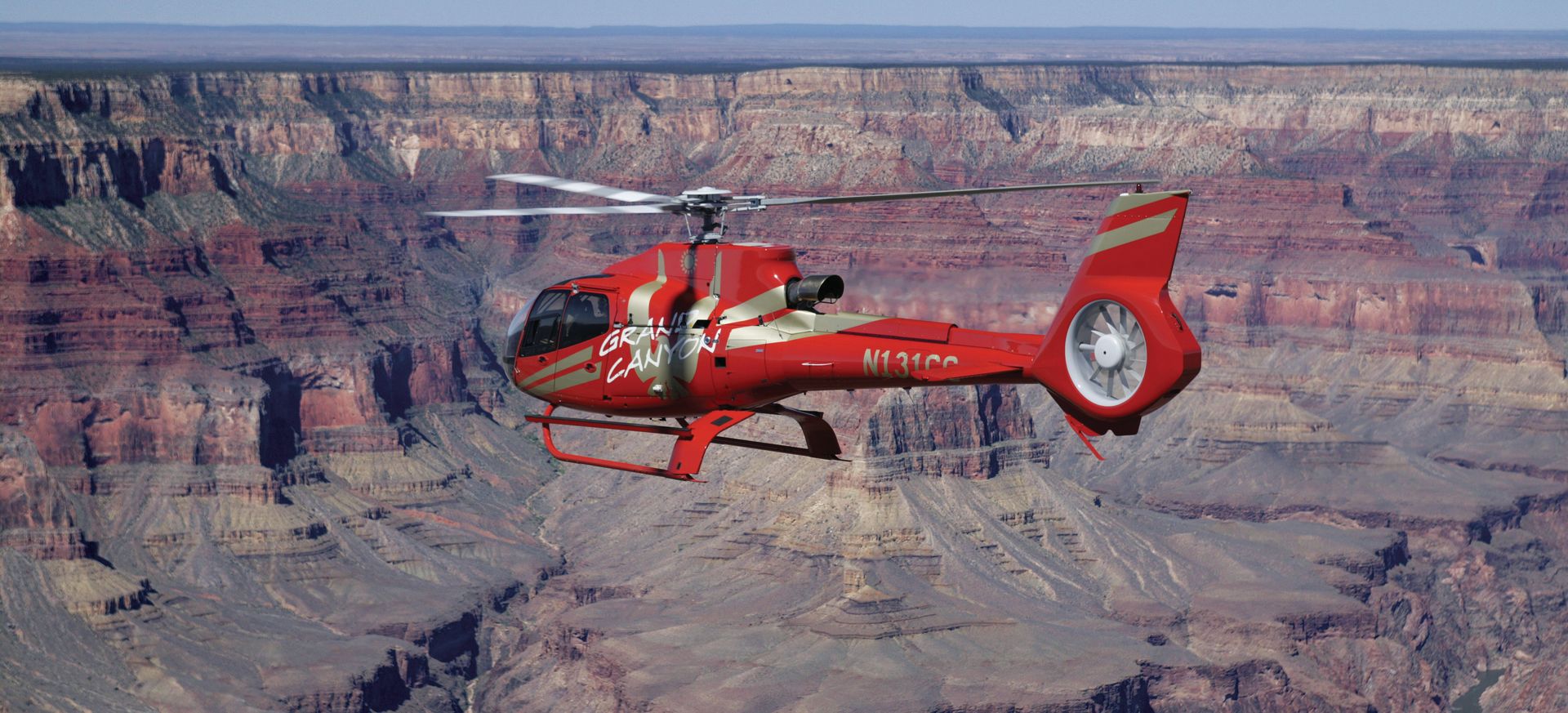 a helicopter tour flies over a grand canyon national park gorge