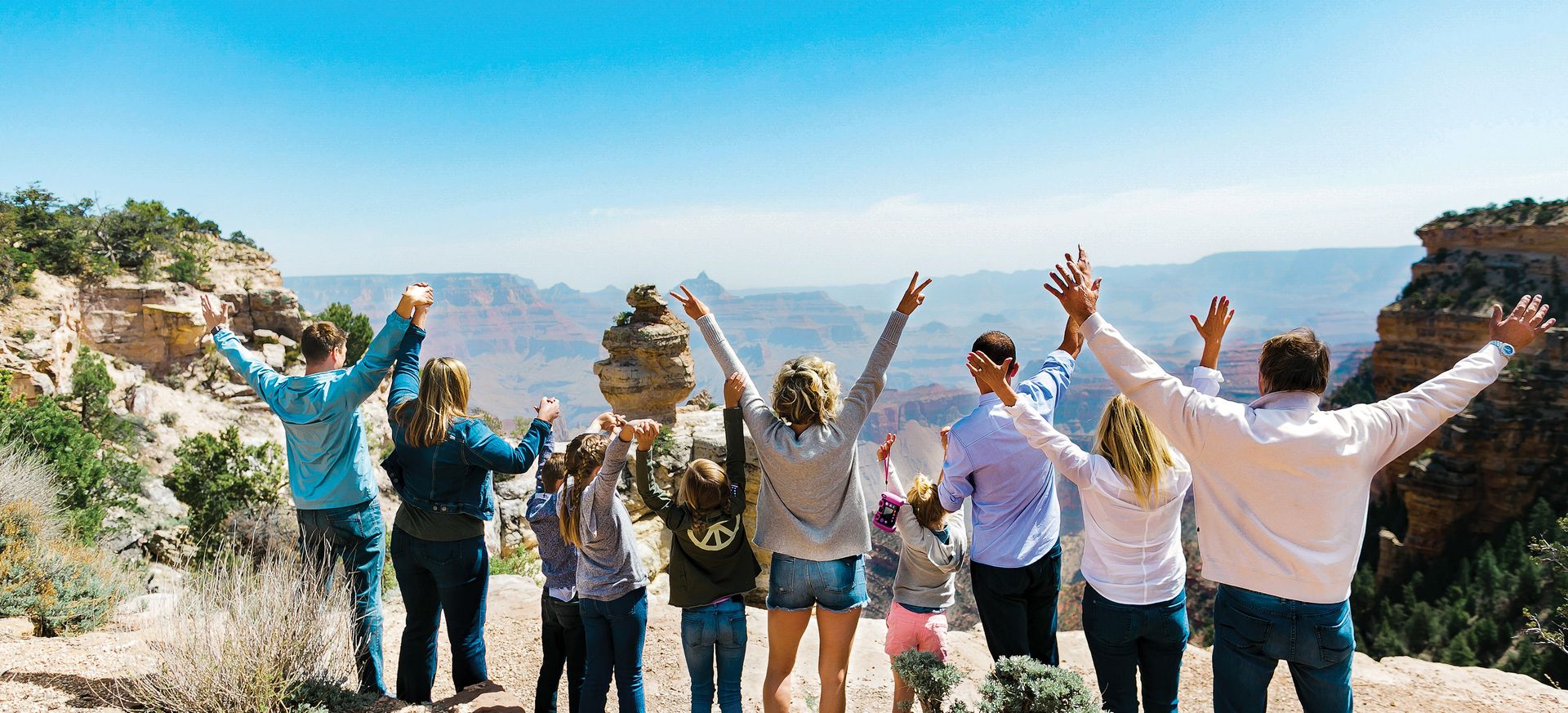 passengers aboard a military-style Hummer vehicle parked at a Grand Canyon lookout point