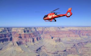 a grand canyon helicopter tour flying over the sunny South Rim