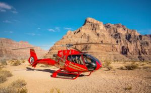 a helicopter tour landed at the bottom of the grand canyon west with a bright blue sky in the background