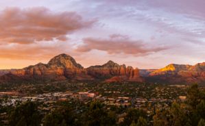 The sun setting over colorful canyon walls found in Sedona, AZ