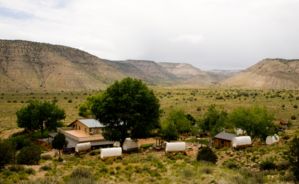 bar 10 ranch with covered wagons scattered throughout the area and forestry and mountains in the background