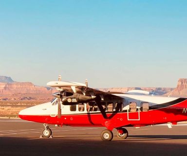 airplane parked at the page municipal airport with tower butte in the distance