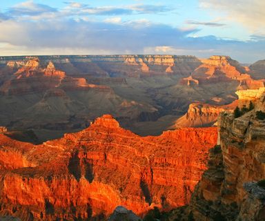 a stunning view of orange grand canyon walls at sunset