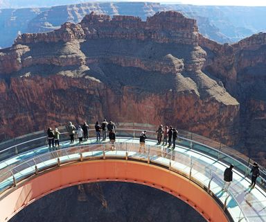 West Rim guests stand atop the glass-bottomed Skywalk Bridge above the Grand Canyon