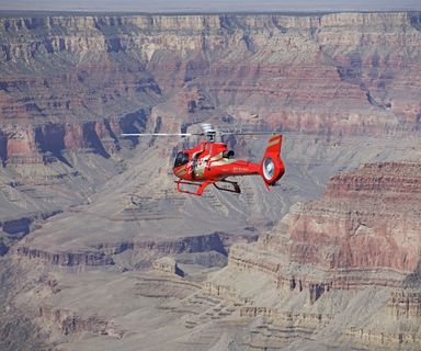 A Grand Canyon helicopter tour flies over the South Rim landscape