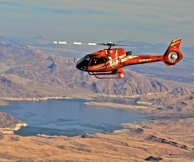 A Grand Canyon helicopter tour flies over the nearby Lake Mead en route to the park.