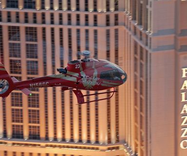 a red helicopter flies past the Palazzo hotel on a Las Vegas tour