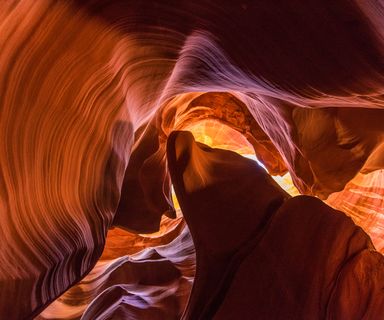 an upward view of the ceiling of Antelope Canyon and the sandstone walls on either side