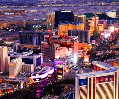 A Las Vegas helicopter tour flies over the Strip casinos at night