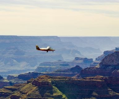 A sightseeing airplane tour seen with the Grand Canyon walls in the distance