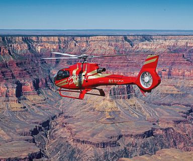 An Ecostar helicopter flies over the Grand Canyon South Rim