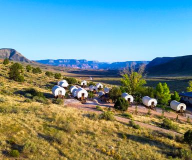 Bar 10 Ranch and its covered wagons located on property with desert scenery surrounding it