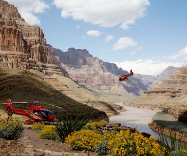 Red helicopter taking off from the bottom of Grand Canyon West.