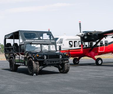 A helicopter and a Hummer vehicle from Papillon's fleet parked art the South Rim