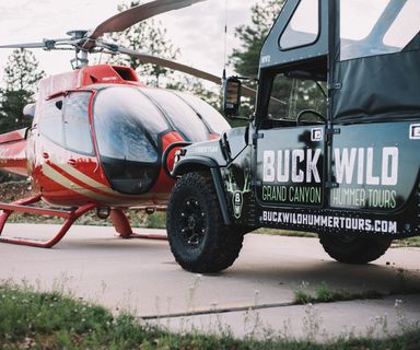 Papillon Hummer and helicopter vehicles parked on the terminal tarmac
